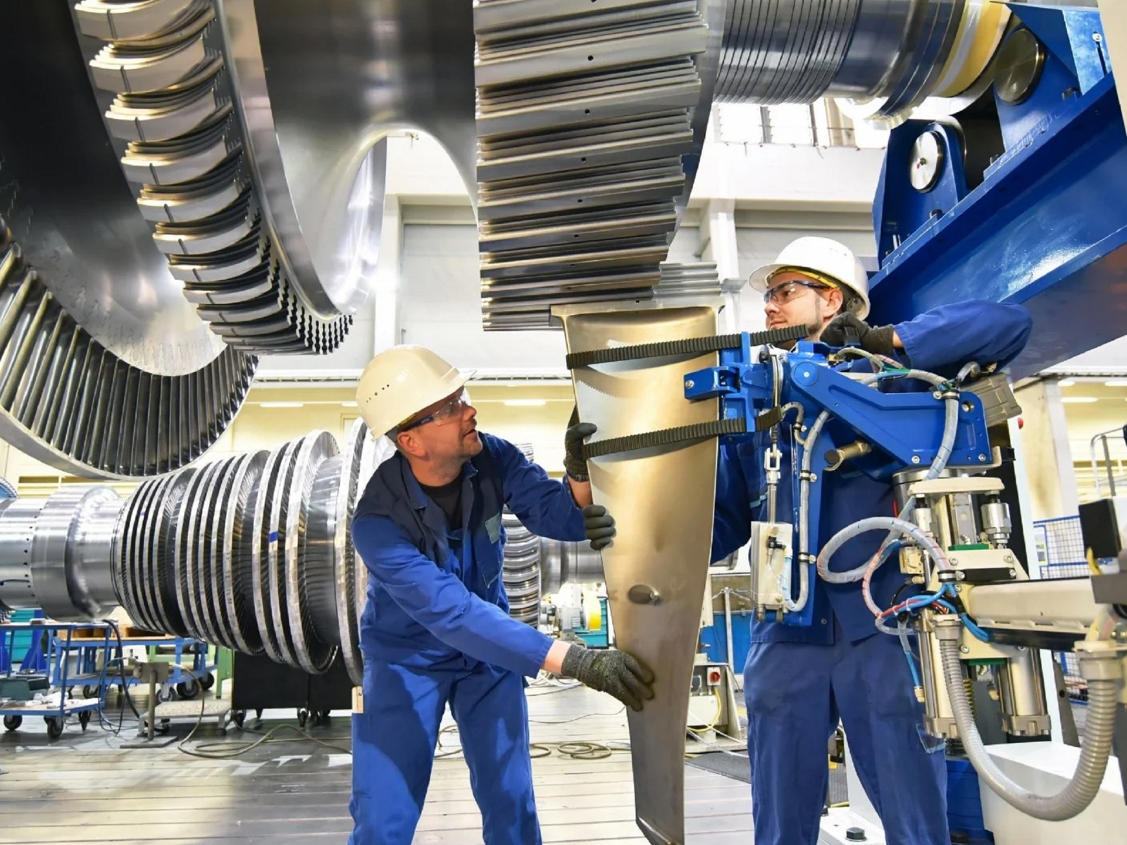Industrial workshop — skilled workers assembling large-scale machinery